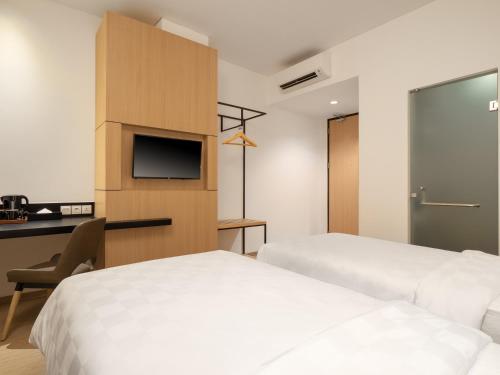 Letto o letti in una camera di Hotel 88 Blok M Jakarta By WH