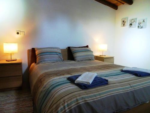 a bedroom with a large bed with two lamps at To Archontiko tis Anastasias in Athienou