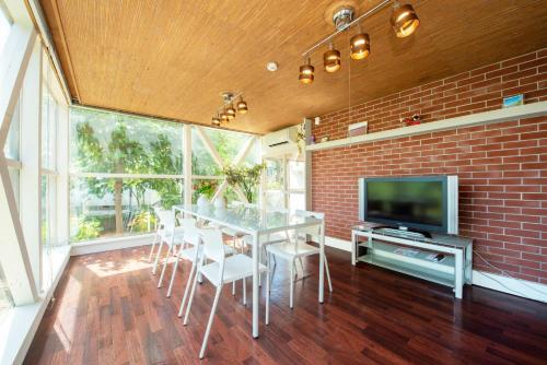 a dining room with a table and a tv at Sapporo - house / Vacation STAY 697 in Sapporo