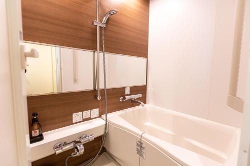 a bathroom with a sink and a bath tub at Wisterian Life Club Toba in Toba