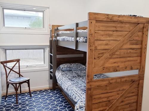 a bedroom with bunk beds with a wooden door at Wisharts Landing in Port Fairy