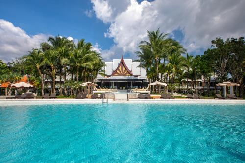 a swimming pool in front of a resort at Natai Beach Resort in Natai Beach