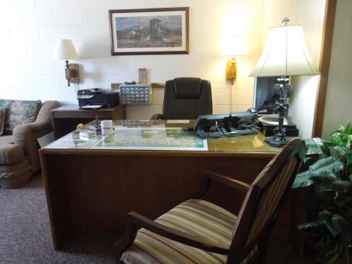 
a desk with a chair and a computer on it at The Pines Motel in Saint Maries

