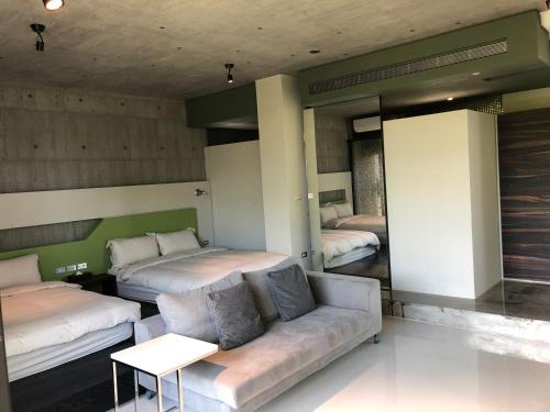 a living room with two beds and a couch at One Piece B&B in Dongshan