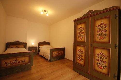 a bedroom with two beds and a large door at Bio Bauernhof - Mini Shetland Ponyhof "Almbauer" in Waidhofen an der Ybbs