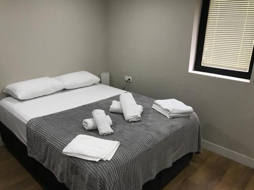a bedroom with a bed with towels on it at D and D hotel in Tbilisi City