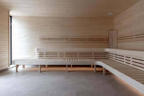 a bench in a room with a wooden wall at Clarion Hotel Sundsvall in Sundsvall