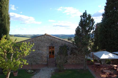 a stone house with a garden and a patio at Hotel Belvedere Di San Leonino in Castellina in Chianti
