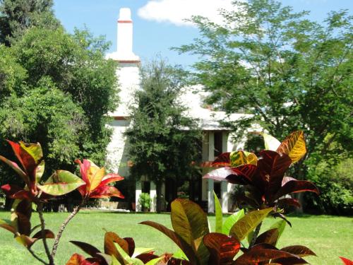 a building with a lighthouse in the background at El Molino Hotel Boutique in Río Verde