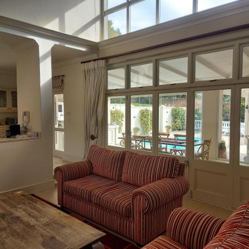 a living room with a couch and a table at Rustic Manor Guest House in Tokai