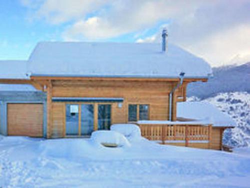 a log cabin with snow on the ground at Lavish Holiday Home in H r mence with Balcony in Hérémence