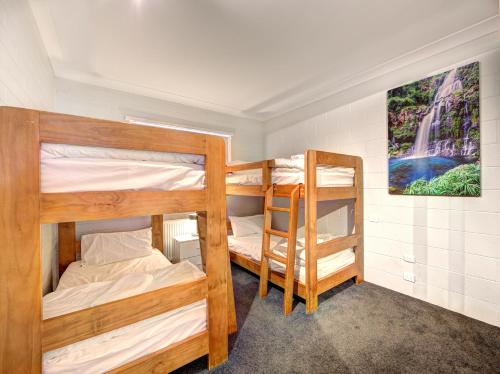 two bunk beds in a small room with a painting at Snow Ski Apartments 36 in Falls Creek