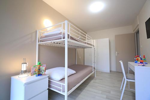 białe łóżko piętrowe w pokoju z biurkiem w obiekcie Appartement de 57m2 vue sur mer et plage w mieście Le Portel