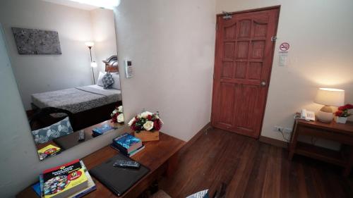 a living room with a table and a room with a door at 1775 Adriatico Suites in Manila