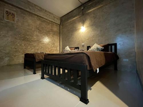 a bedroom with a bed in a room at Amante Baristro Hotel & Cafe' @Pua in Nan