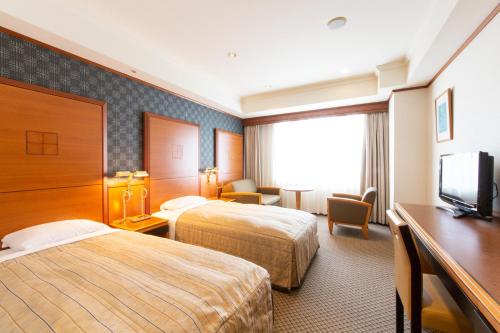 Tempat tidur dalam kamar di ホテルルポール麹町