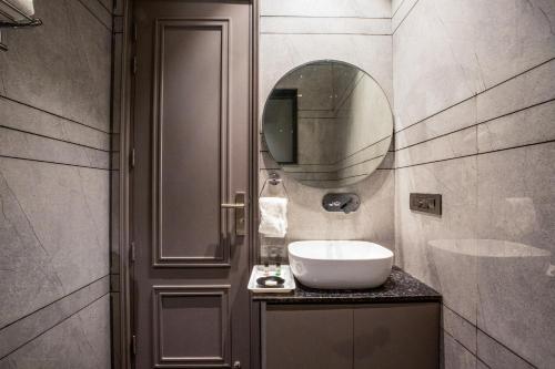 a bathroom with a sink and a mirror at Hotel Viasora in Pānīpat