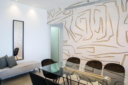 a living room with a glass table and chairs at Midtown Towers TLV in Tel Aviv