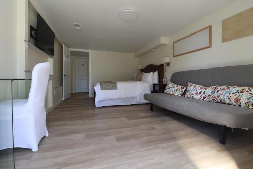 a living room with a couch and a bed at Victoria Gorge Waterway Vacation Home in Victoria