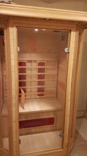a wooden display cabinet with a drawer in it at Dom O Niebieskich Okiennicach in Gryfów Śląski
