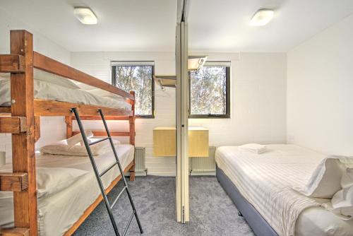 a bedroom with two bunk beds and a desk at Snow Ski Apartments 22 in Falls Creek