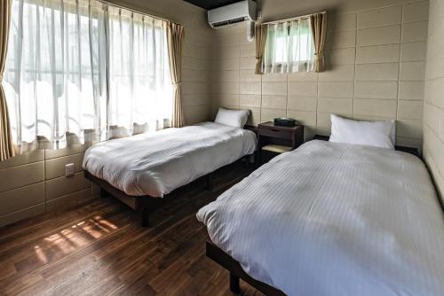 a bedroom with two beds and a window at LEGO in Uruma