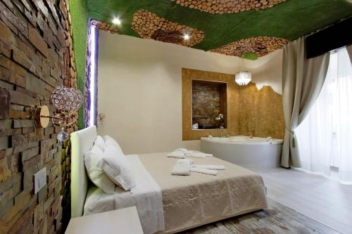 a bathroom with a bed and a bath tub at Suite Paradise Rome Guest Rooms in Rome