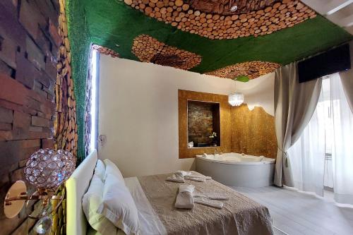 a bathroom with a bed and a tub in a room at Suite Paradise Rome Guest Rooms in Rome