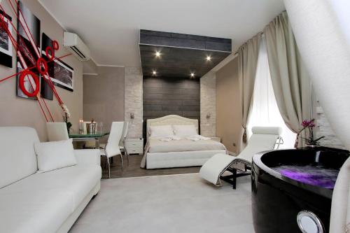 a bedroom with a bed and a tub in a room at Suite Paradise Rome Guest Rooms in Rome