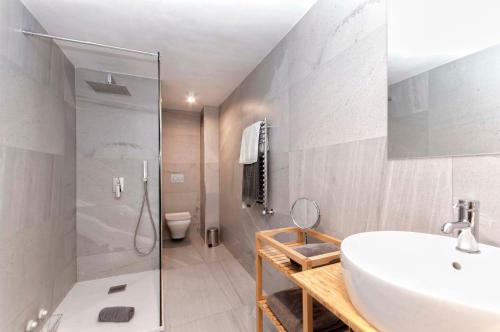 a bathroom with a sink and a shower and a toilet at AticoColón21 in Alicante