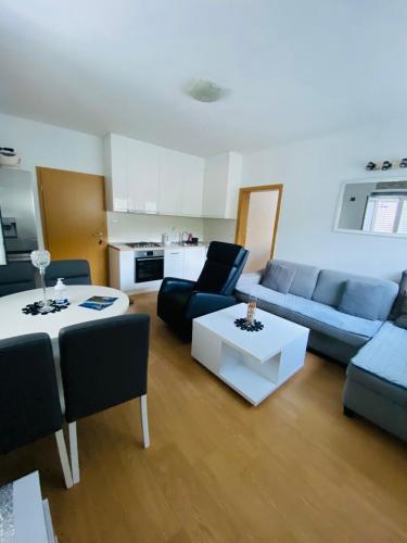 a living room with a couch and a table at Guest House Ruža in Sobra