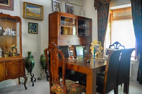 a dining room with a wooden table and chairs at La Vieja Parra in La Puerta de Segura