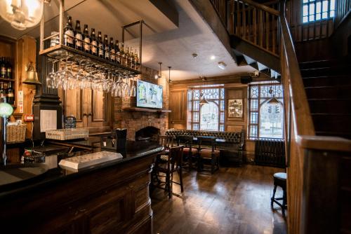 a bar in a pub with tables and chairs at Lower Turks Head in Manchester