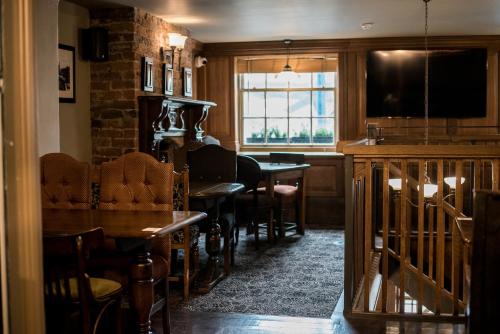 a living room with a table and a dining room at Lower Turks Head in Manchester
