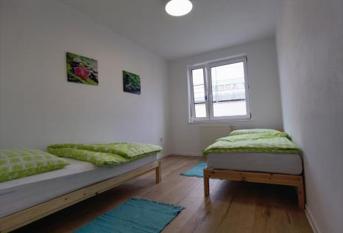 a white room with a bed and a window at Apartmán Športová in Trnava