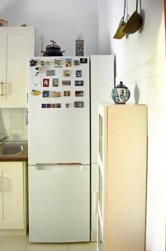 a kitchen with a white refrigerator at La Vieja Parra in La Puerta de Segura