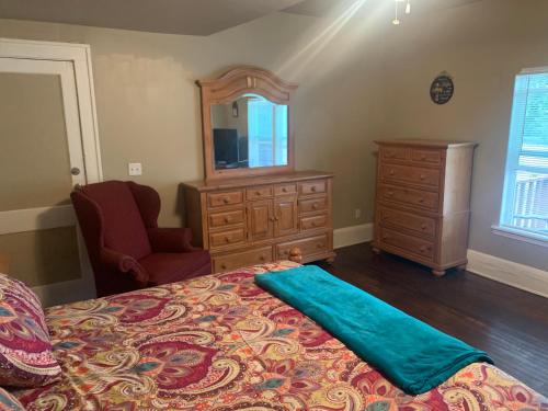 a bedroom with a bed and a dresser and a mirror at Magnificent Place-Moreland in Atlanta