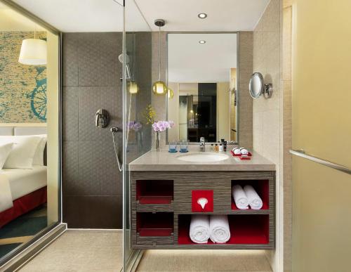 a bathroom with a sink, mirror, and toilet at Radisson Collection Hyland Shanghai in Shanghai