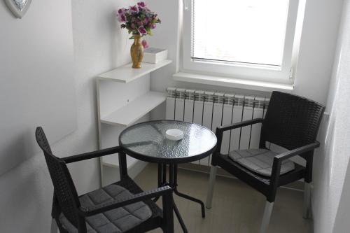 a table and two chairs and a table with a table and a table at Apartments Luke in Dubrave Gornje