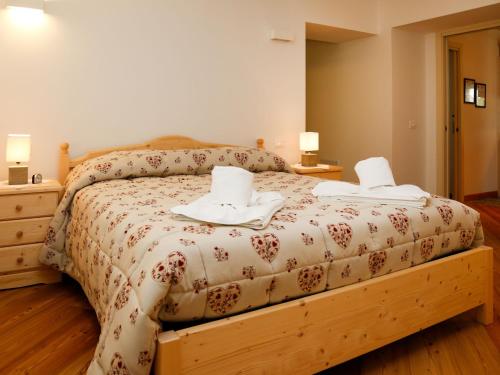 a bedroom with a bed with two towels on it at Apartment App- A - Cjase Fravins by Interhome in Raveo