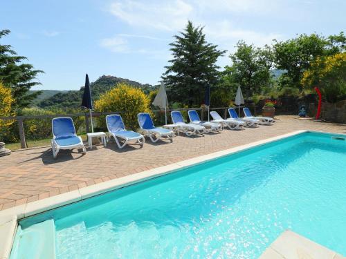 a group of chairs and a swimming pool at Holiday Home Poggio Velluto by Interhome in Seggiano