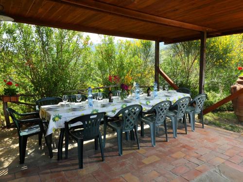 a dining table and chairs on a patio at Holiday Home Poggio Velluto by Interhome in Seggiano