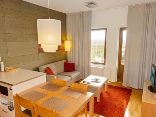 uma sala de estar com um sofá e uma mesa em Holiday Home Ski chalets vii 7403 by Interhome em Ylläs