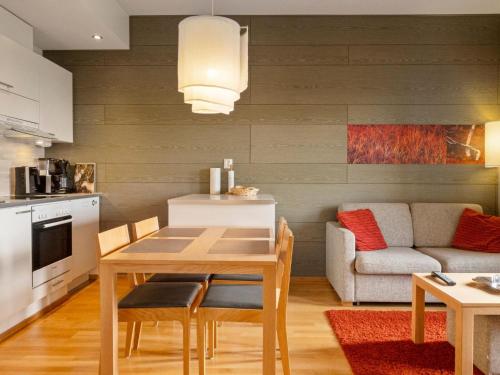 a kitchen and living room with a table and a couch at Holiday Home Ski chalets vii 7403 by Interhome in Ylläs