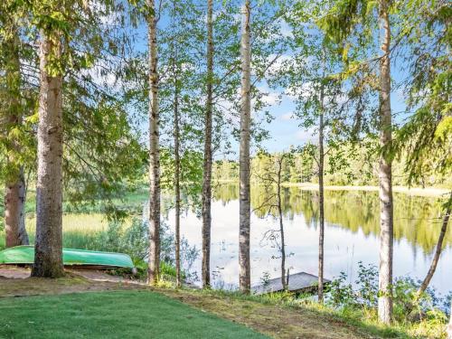 a view of a lake through the trees at Holiday Home Koskisaari by Interhome in Kortteinen