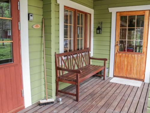 eine Holzbank auf der Veranda eines Hauses in der Unterkunft Holiday Home Saikulevi by Interhome in Levi