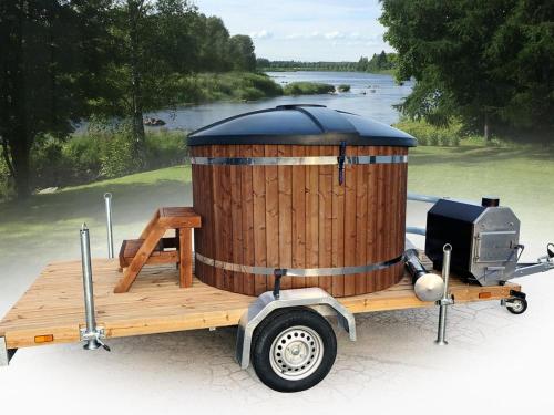 a wooden boat with a barrelasteryastery on the back at Holiday Home Koskenniska by Interhome in Kortteinen