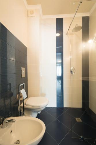 a bathroom with a toilet and a sink and a shower at Holiday Village Lozenets in Lozenets
