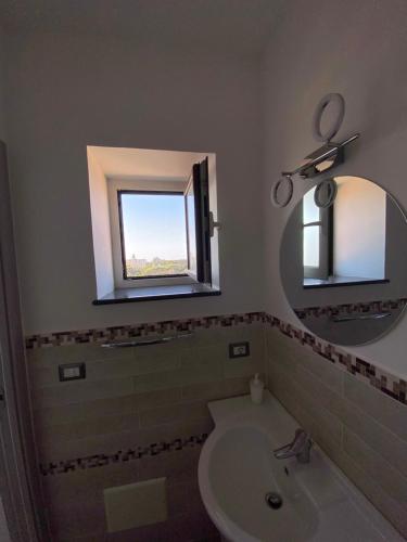 a bathroom with a sink and a mirror at La casetta del borgo in Agerola