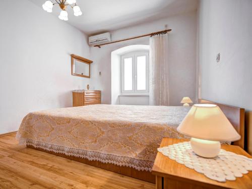 a bedroom with a bed and a table with a lamp at Apartment Branko by Interhome in Sveti Juraj